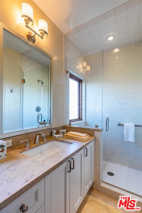 1870 Mango Way Los Angeles, CA 90049 - Photo 24 of 28 a bathroom with a sink and a mirror