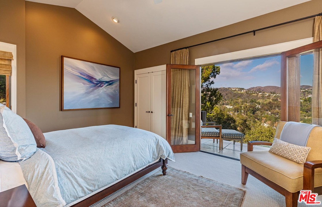 1870 Mango Way Los Angeles, CA 90049 - Photo 25 of 28 a bedroom with a large bed couch and a large window