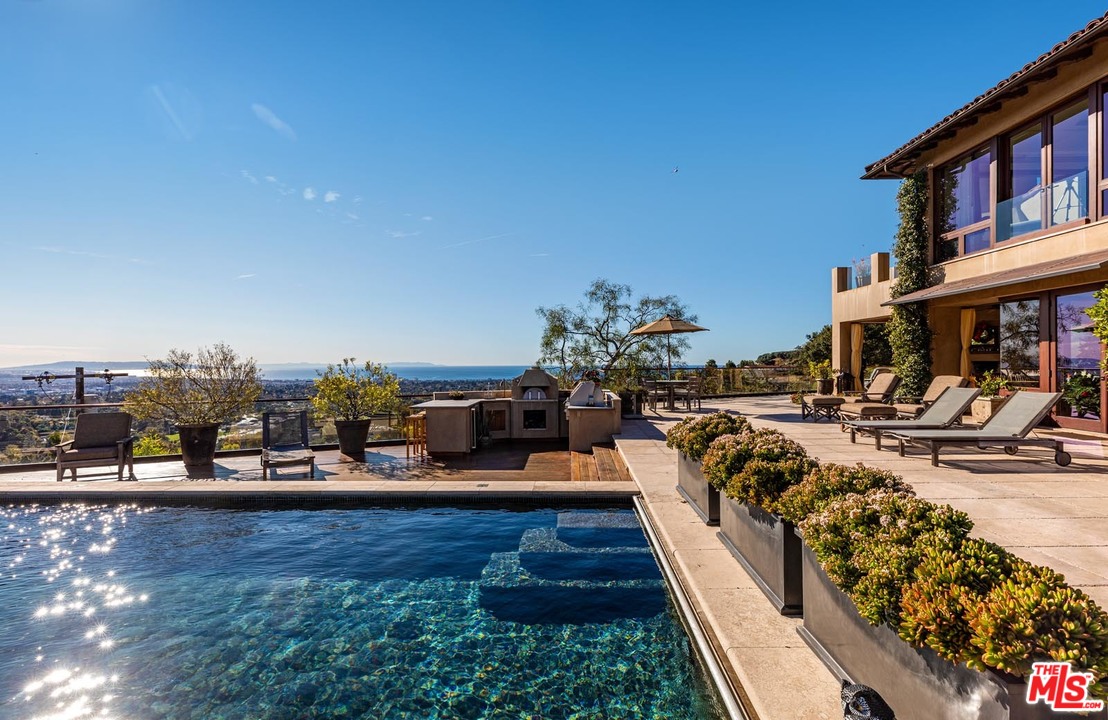 1870 Mango Way Los Angeles, CA 90049 - Photo 4 of 28 a view of a house with sitting area and sitting area