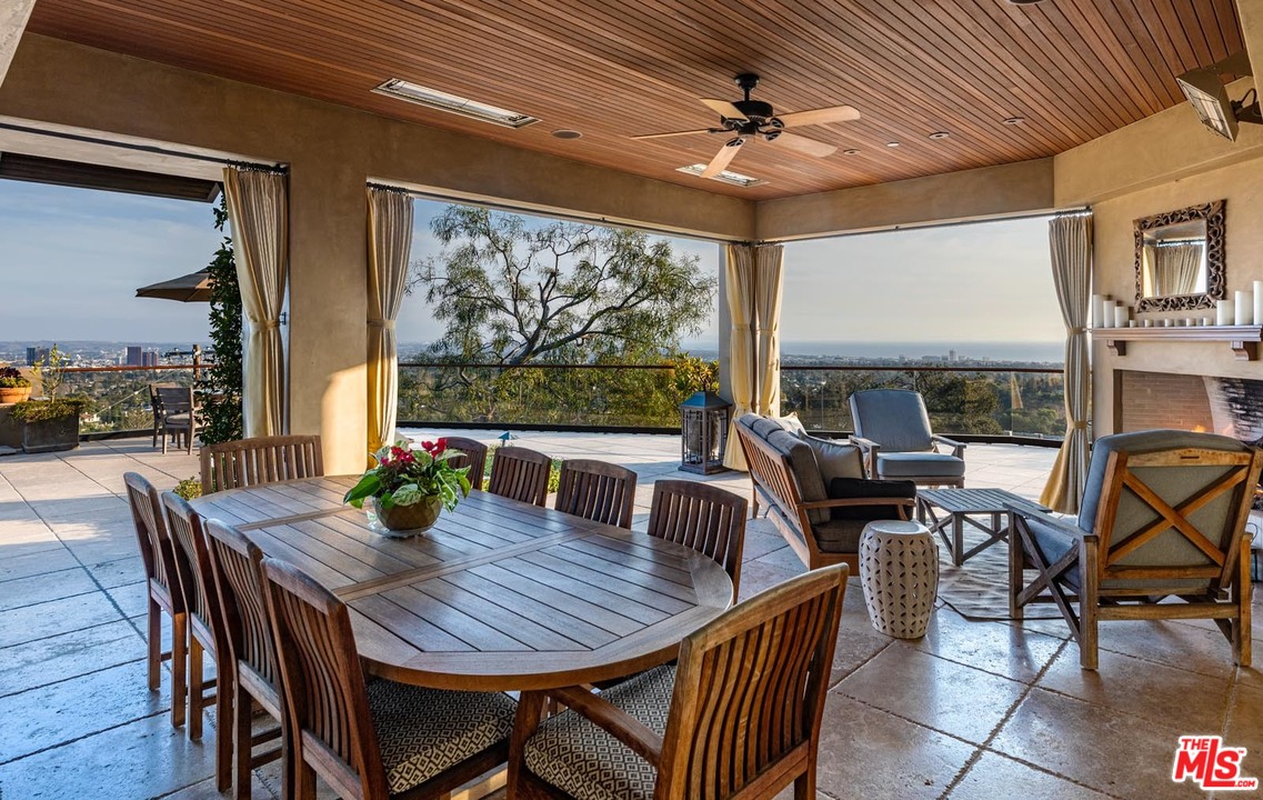 1870 Mango Way Los Angeles, CA 90049 - Photo 7 of 28 a view of a dining room with furniture large windows and wooden floor