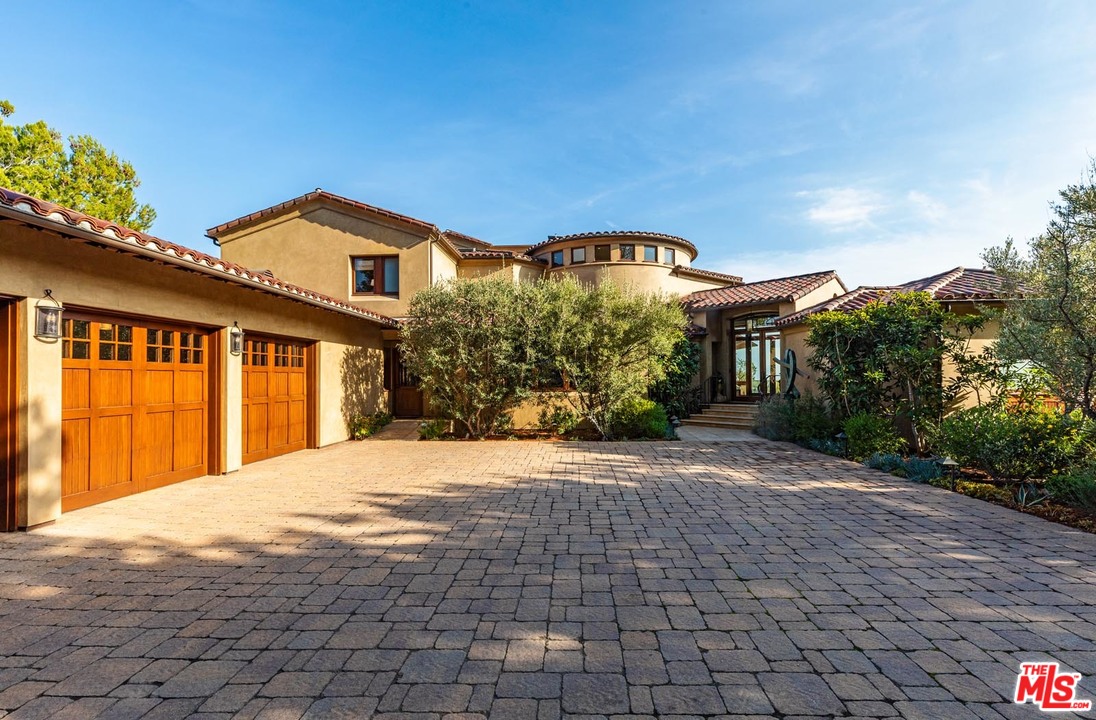 1870 Mango Way Los Angeles, CA 90049 - Photo 8 of 28 a front view of a house with a yard and potted plants