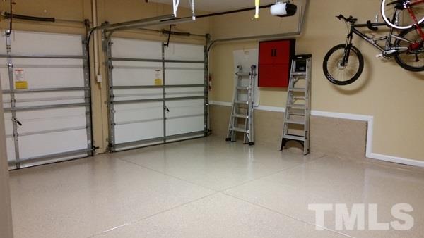 5435 Brandy Bay Road Raleigh, NC 27613 - Photo 13 of 25 Epoxy flooring, storage cabinet, storage shelving, racks, two car garage, with pull down attic storage, fully finished garage with custom paint