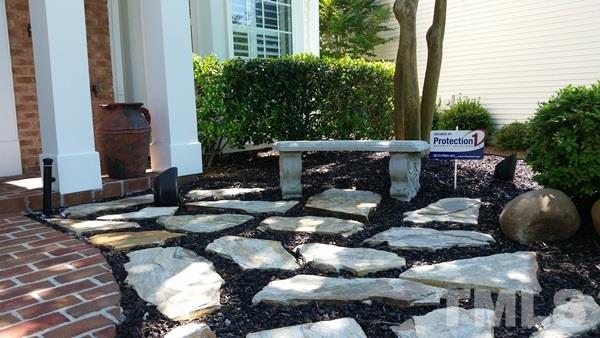5435 Brandy Bay Road Raleigh, NC 27613 - Photo 18 of 25 Custom landscaping, square columns, flat rock, outdoor uplights, custom front walkway,
