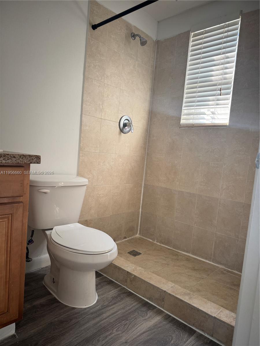 7130 Rue Versailles Drive, Unit 4 Miami Beach, FL 33141 - Photo 7 of 12 a bathroom with a toilet and a shower