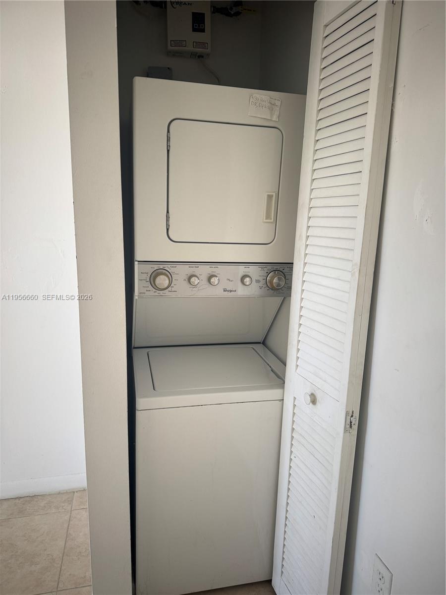 7130 Rue Versailles Drive, Unit 4 Miami Beach, FL 33141 - Photo 9 of 12 a utility room with dryer and washer