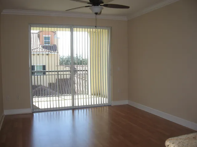 a view of a livingroom with wooden floor and a window
