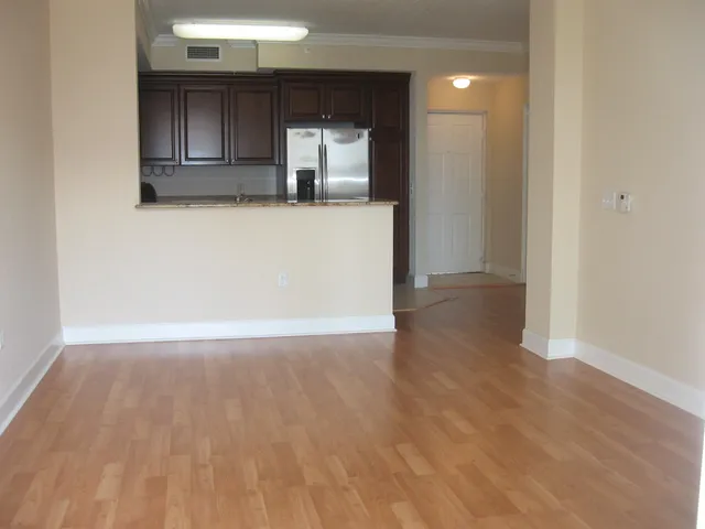 a view of a kitchen with wooden floor and a sink