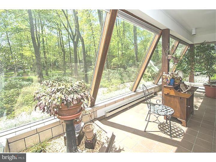 1501 Gypsy Hill Road Lower Gwynedd, PA 19002 - Photo 19 of 24 a living room with a floor to ceiling window and wooden floor