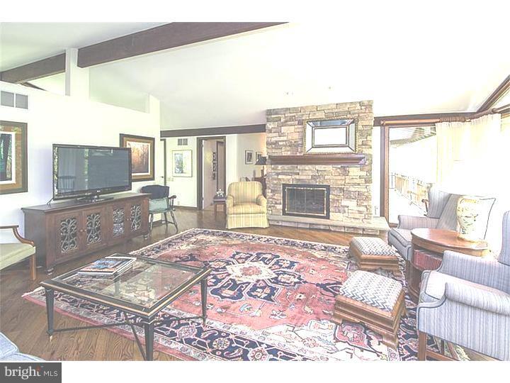 1501 Gypsy Hill Road Lower Gwynedd, PA 19002 - Photo 5 of 24 a living room with furniture a flat screen tv and a fireplace