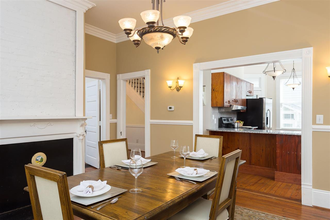 316 North Boundary Street Raleigh, NC 27604 - Photo 11 of 23 a dining room with wooden floor a chandelier a wooden table and chairs