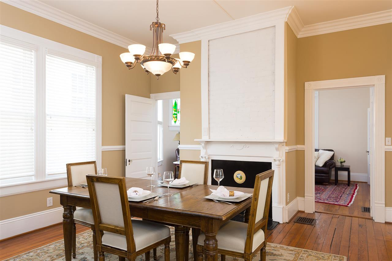 316 North Boundary Street Raleigh, NC 27604 - Photo 10 of 23 a dining room with wooden floor a chandelier a wooden table and chairs