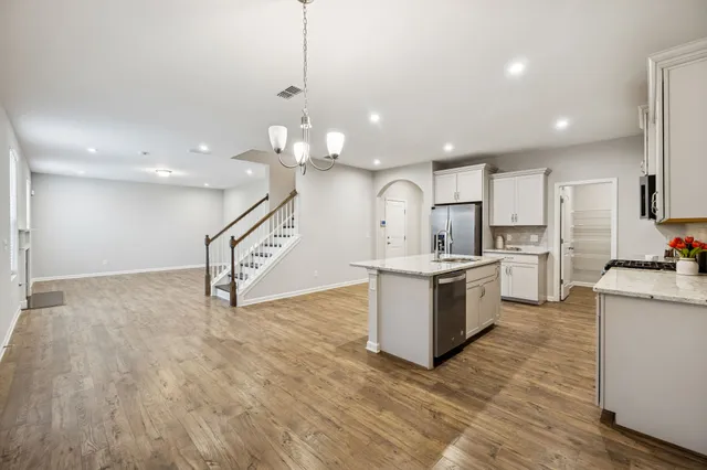 a large kitchen with sink cabinets and stainless steel appliances
