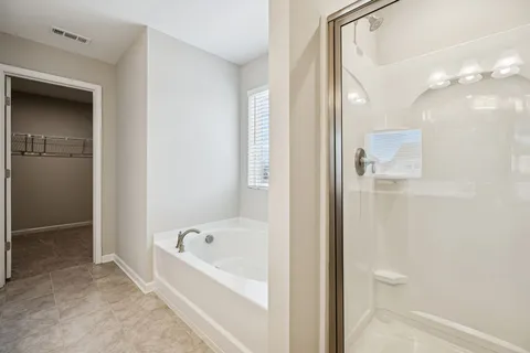 a bathroom with a bathtub and a shower