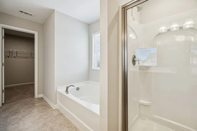 a bathroom with a bathtub and a shower