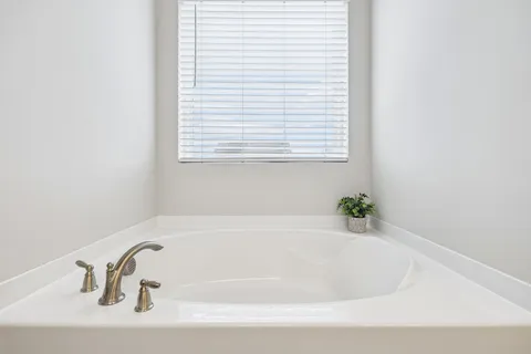 a white bath tub sitting in a bathroom