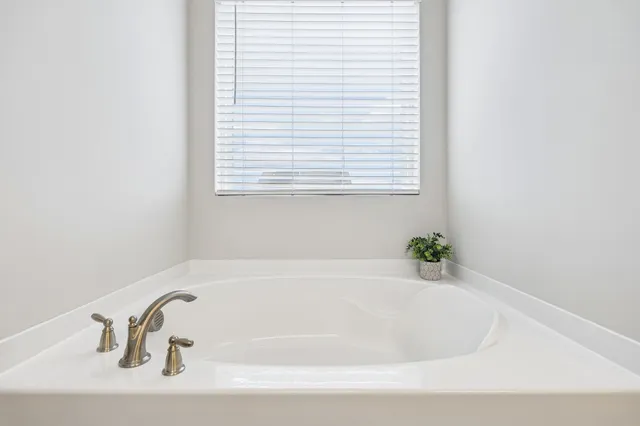 a white bath tub sitting in a bathroom