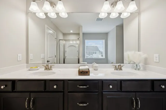 a bathroom with a sink vanity and a mirror