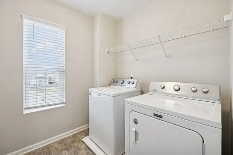 a view of storage and utility room with washer and dryer