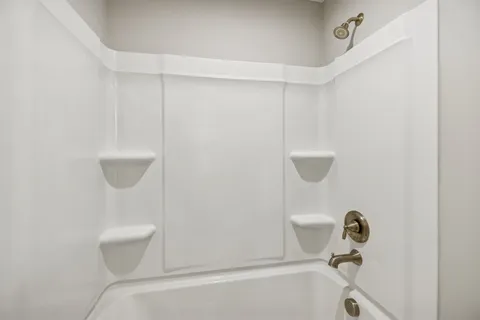 a bathroom with a toilet and a bathtub