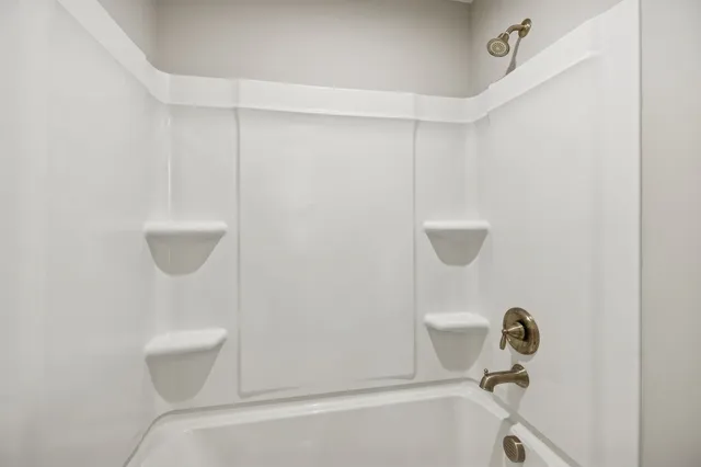 a bathroom with a toilet and a bathtub