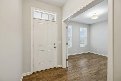 an empty room with closet and wooden floor