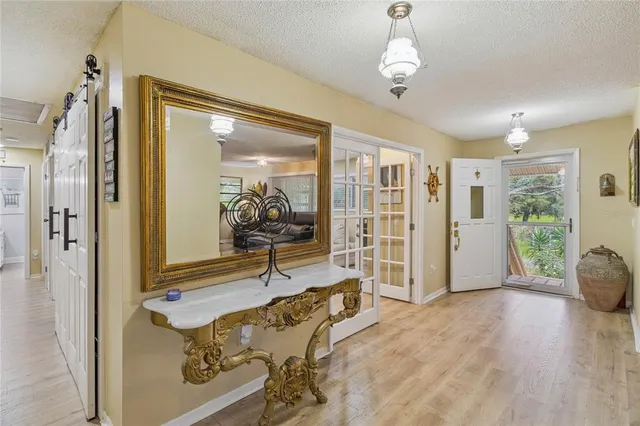 a open kitchen with stainless steel appliances kitchen island granite countertop a white table and chairs