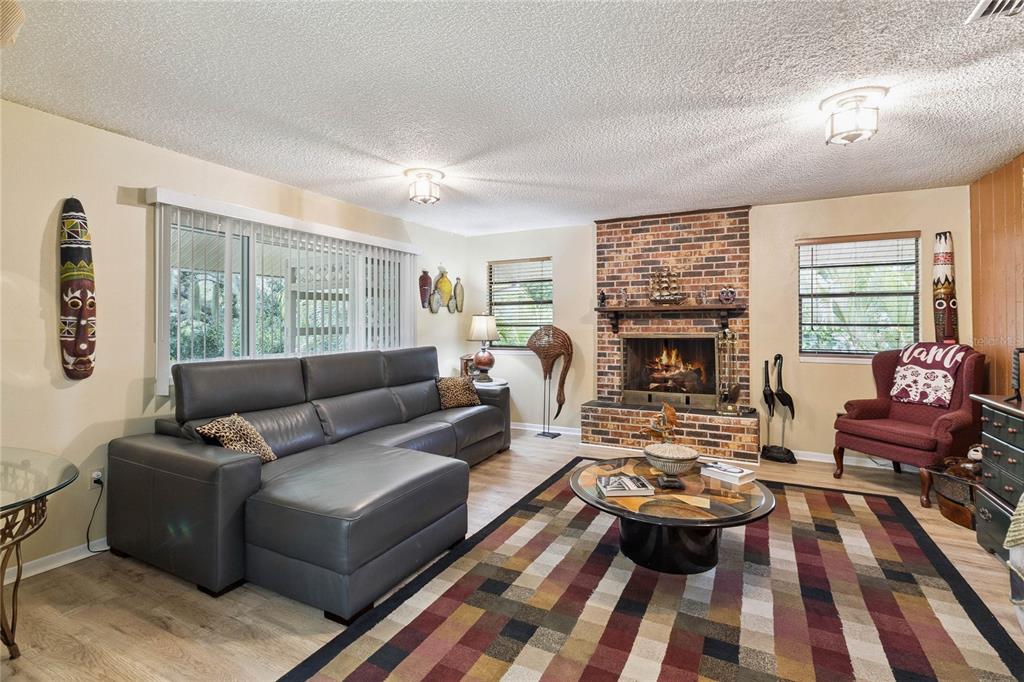 4191 Corey Road Malabar, FL 32950 - Photo 12 of 53 a living room with furniture and a fireplace