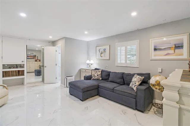 a utility room with dryer washer and a view of living room