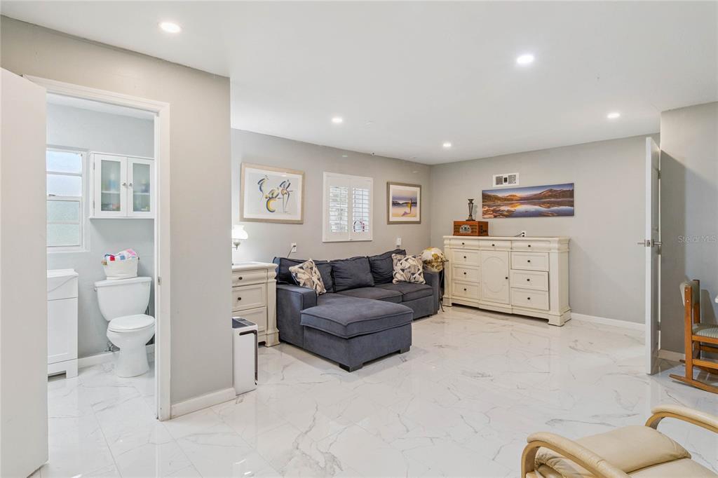 4191 Corey Road Malabar, FL 32950 - Photo 25 of 53 a living room with furniture and a flat screen tv