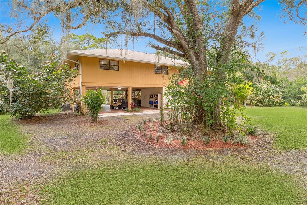 4191 Corey Road Malabar, FL 32950 - Photo 37 of 53 a view of a house with a yard and a garage