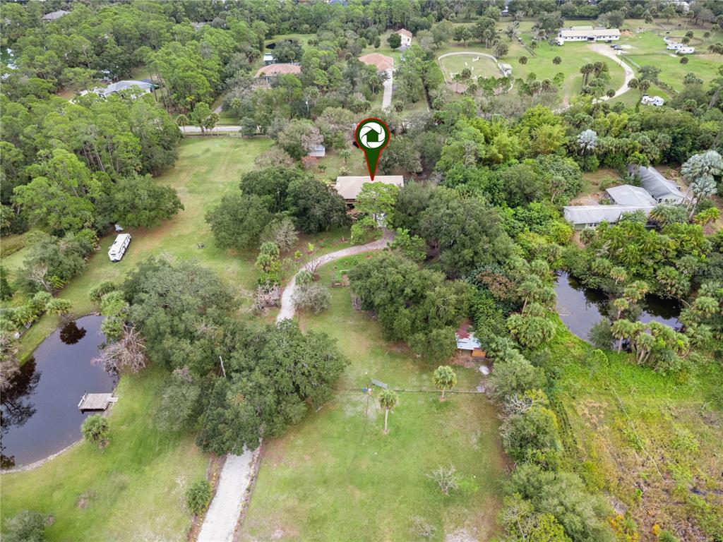 4191 Corey Road Malabar, FL 32950 - Photo 44 of 53 a view of a yard with plants and large trees