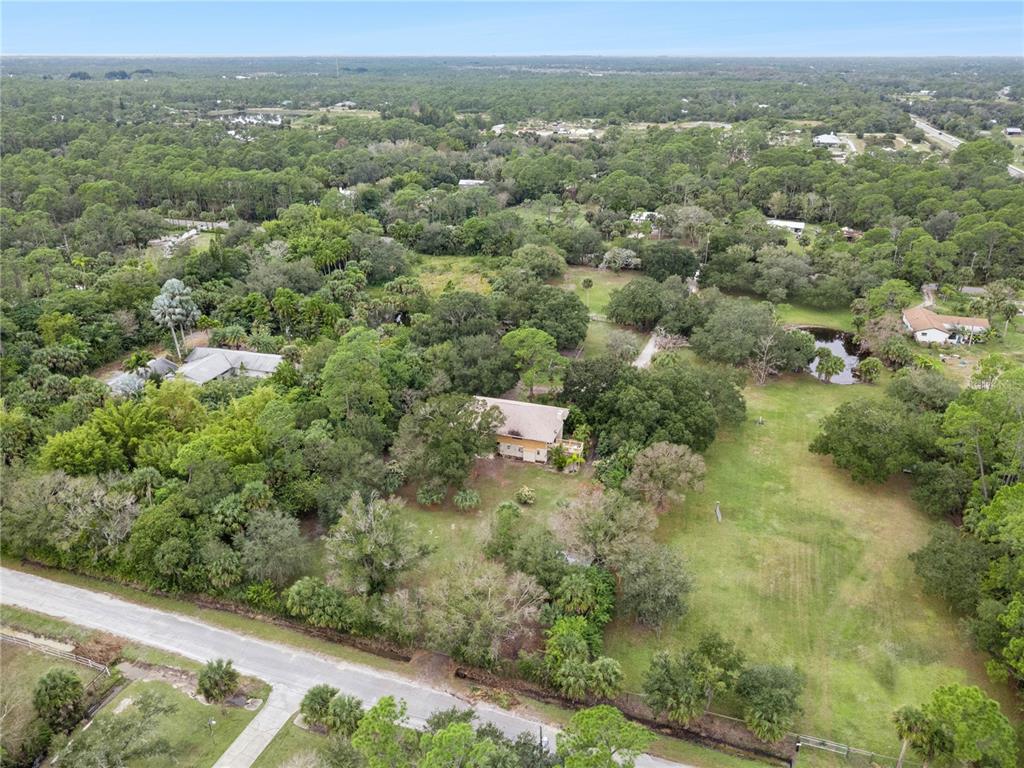 4191 Corey Road Malabar, FL 32950 - Photo 47 of 53 an aerial view of residential houses with outdoor space and trees