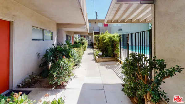 a view of a house with plants and flowers