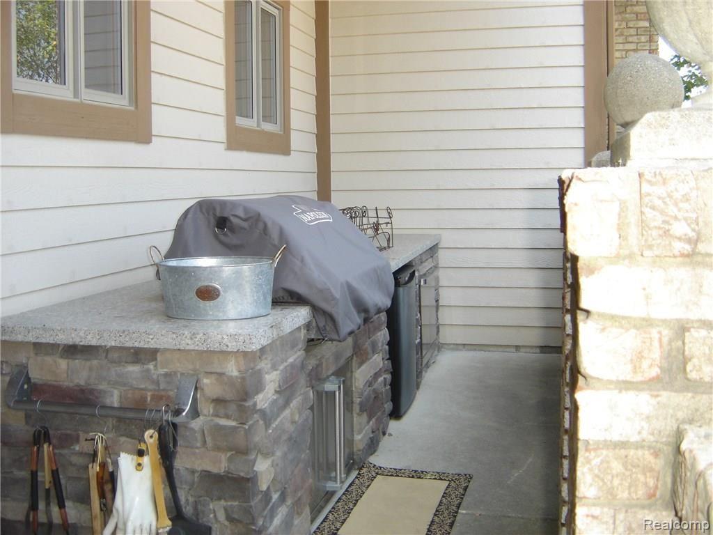 2829 Six Mile Road South Lyon, MI 48178 - Photo 17 of 46 Outdoor kitchen has work area and includes grill and frig.