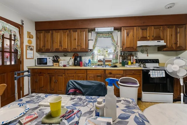 a kitchen with a sink and a stove top oven