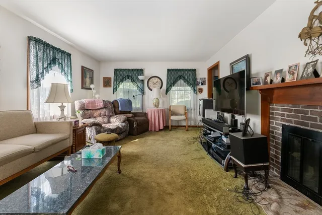 a living room with furniture a rug and a fireplace