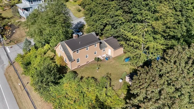 an aerial view of a house with a yard