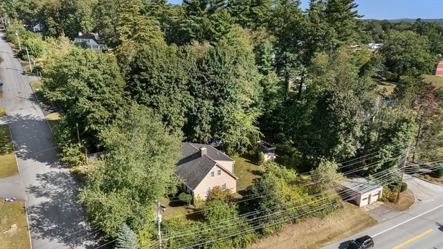 an aerial view of a house with yard