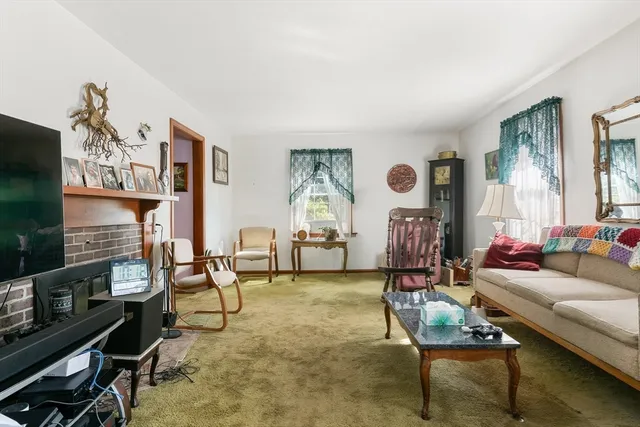 a living room with fireplace furniture and a flat screen tv