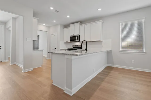 a view of a kitchen with electric appliances