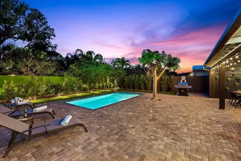 a view of a backyard with sitting area