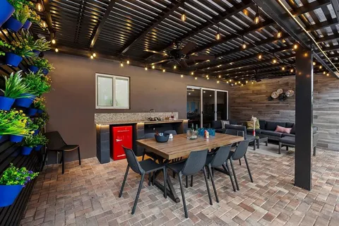 a view of a dinning table and chairs in patio
