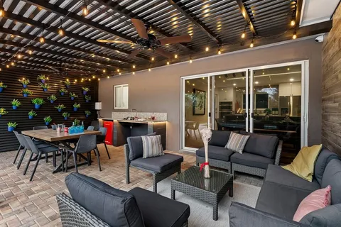 a view of a dining room with furniture and chandelier