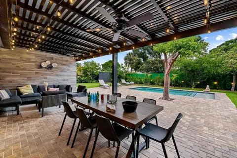 a view of a house with backyard and sitting area