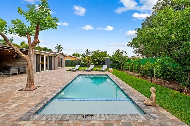 a view of a house with backyard porch and sitting area