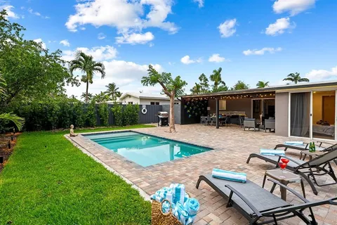 a view of a backyard with sitting area