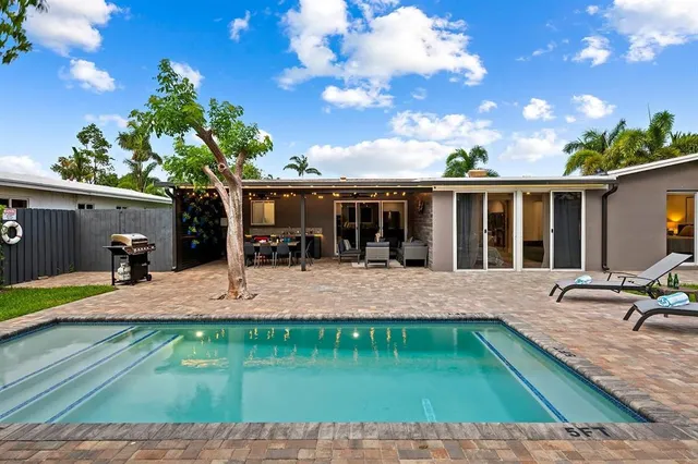 a view of a backyard with sitting area