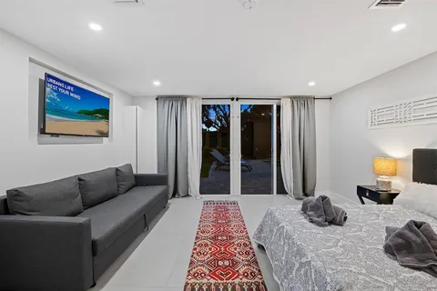 a bedroom with furniture and painting on the wall