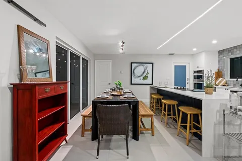 a dining room with furniture and window