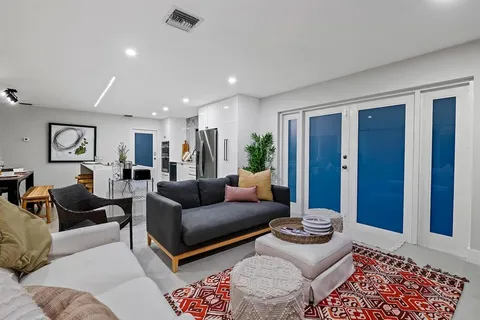 a living room with furniture and a rug